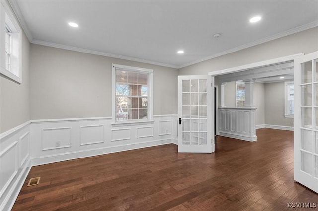 spare room with french doors, ornamental molding, and dark hardwood / wood-style floors