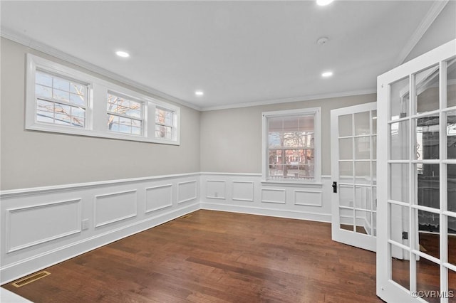 unfurnished room featuring dark hardwood / wood-style flooring, french doors, and crown molding