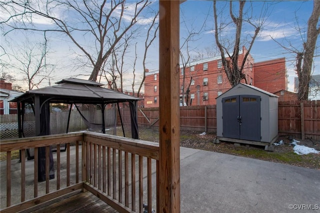 deck with a gazebo and a shed