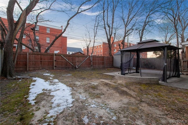 snowy yard featuring a gazebo