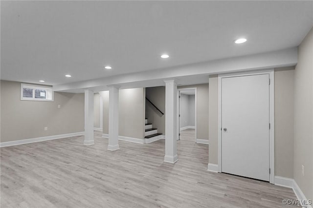 basement with light hardwood / wood-style flooring