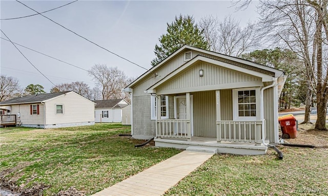 bungalow-style house with covered porch and a front lawn