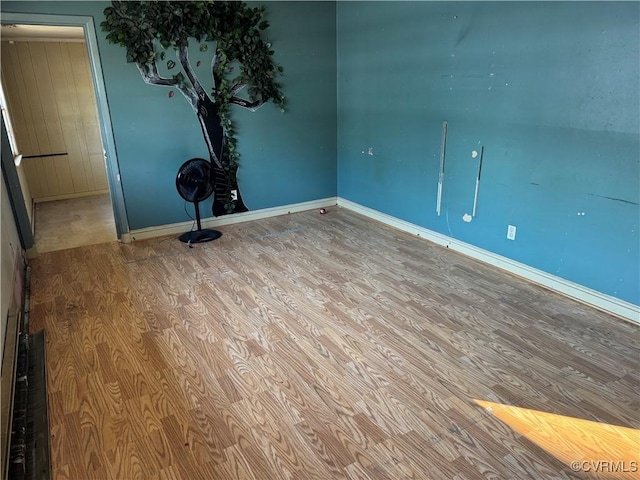 empty room with hardwood / wood-style flooring