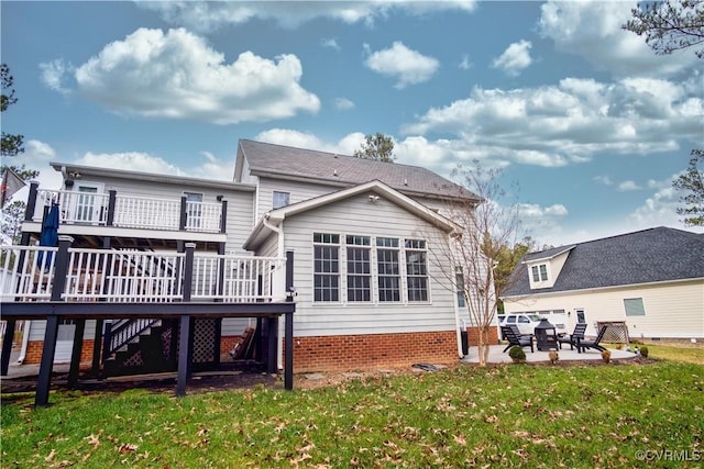 rear view of property featuring a yard, a deck, and a patio area