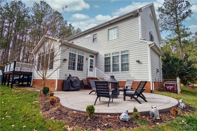 back of house featuring a patio area and a yard