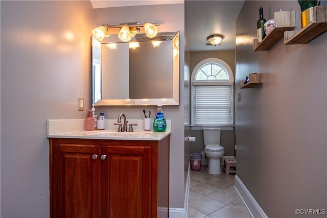 bathroom with vanity, tile patterned flooring, and toilet