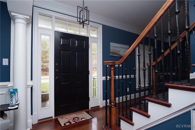 entrance foyer with crown molding, a wealth of natural light, and dark hardwood / wood-style floors