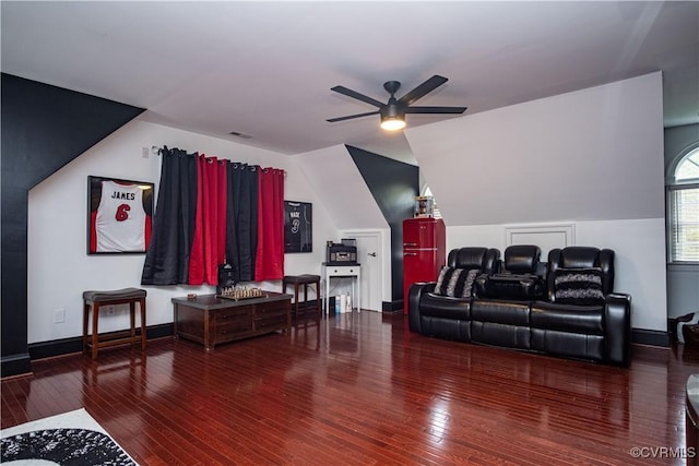 home theater room with lofted ceiling, wood-type flooring, and ceiling fan