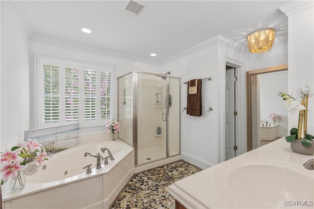 bathroom with plus walk in shower, ornamental molding, and vanity