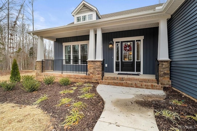 view of exterior entry with a porch