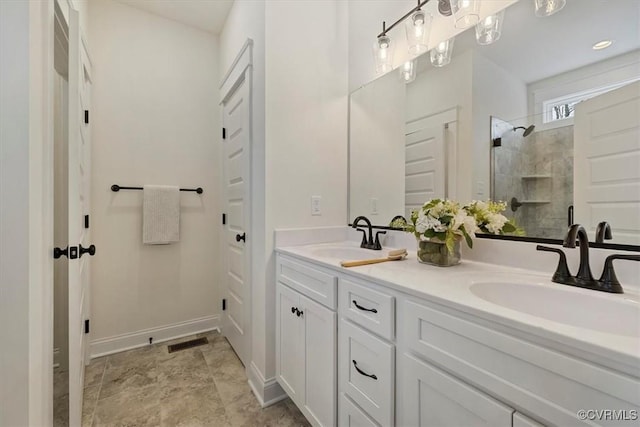 bathroom with vanity and a shower with shower door