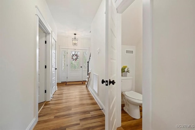 interior space featuring a notable chandelier and light hardwood / wood-style floors