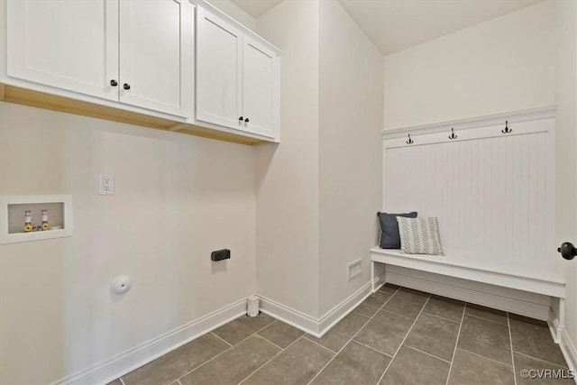 washroom with cabinets, hookup for a washing machine, dark tile patterned floors, and electric dryer hookup