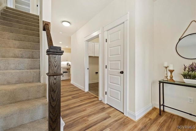 stairway with hardwood / wood-style flooring