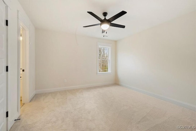 empty room with light colored carpet and ceiling fan