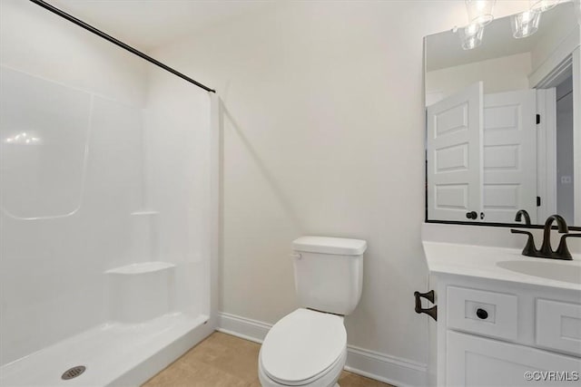 bathroom with vanity, toilet, and walk in shower