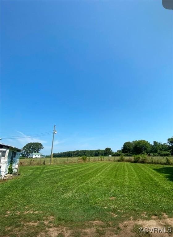 view of yard with a rural view