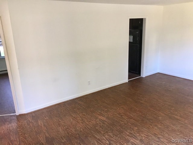 empty room with dark hardwood / wood-style floors