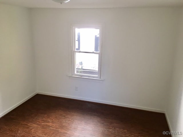 unfurnished room featuring dark wood-type flooring