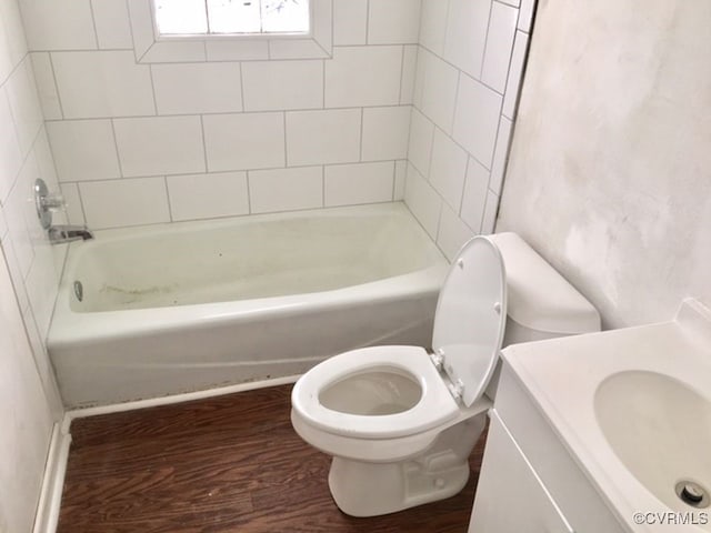 full bathroom with wood-type flooring, vanity, toilet, and tiled shower / bath