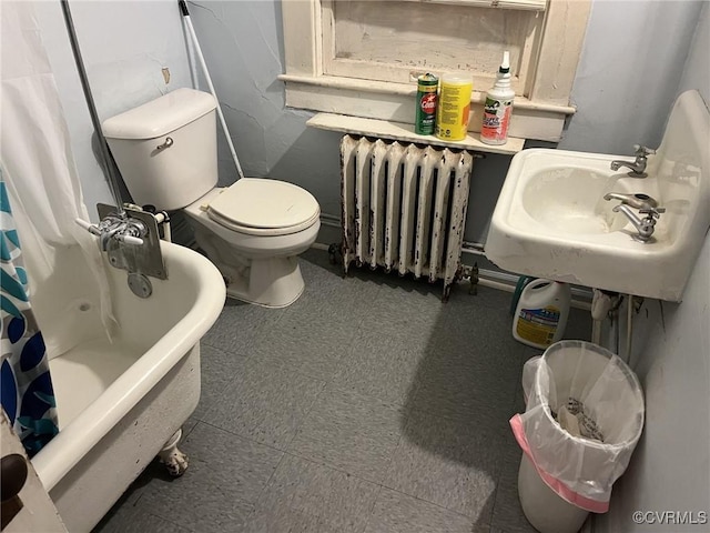 full bathroom featuring shower / bathtub combination with curtain, sink, radiator heating unit, and toilet