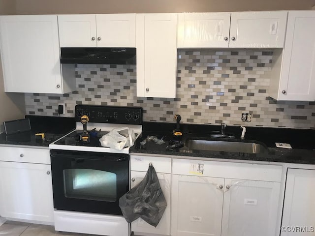 kitchen with white range with electric cooktop, decorative backsplash, and white cabinets