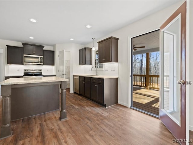 kitchen with stainless steel appliances, recessed lighting, dark wood-type flooring, and a sink