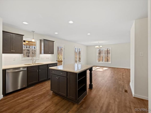 kitchen with a sink, visible vents, dark wood-type flooring, and stainless steel dishwasher