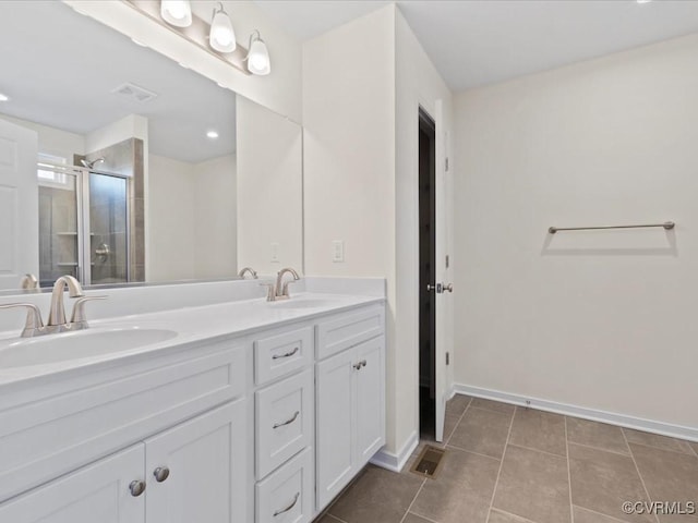 full bath with a stall shower, tile patterned flooring, visible vents, and a sink