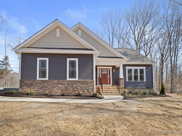 craftsman-style home with stone siding