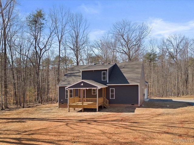 view of front of property with crawl space, a garage, dirt driveway, and a deck