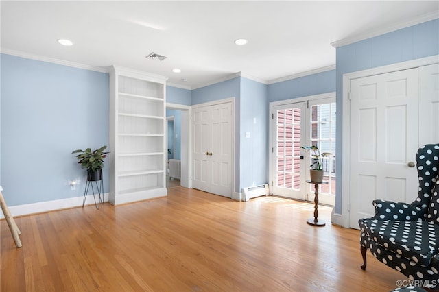 unfurnished room with a baseboard heating unit, light hardwood / wood-style flooring, french doors, and crown molding