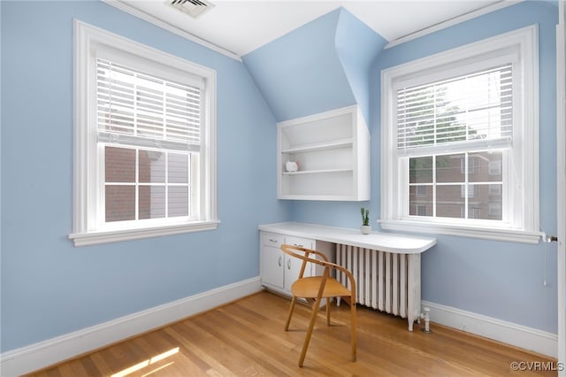 office area featuring crown molding, radiator heating unit, and light wood-type flooring