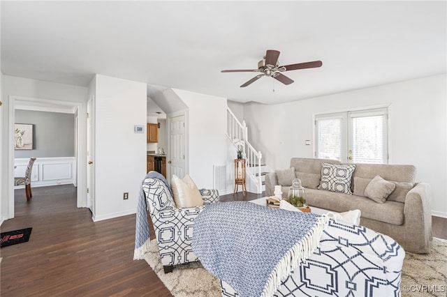 living room featuring ceiling fan and dark hardwood / wood-style flooring