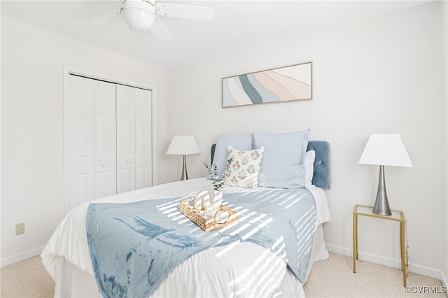 carpeted bedroom with ceiling fan and a closet