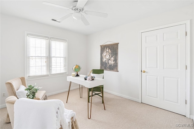 home office with light carpet and ceiling fan