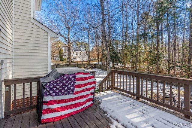 snow covered deck with grilling area