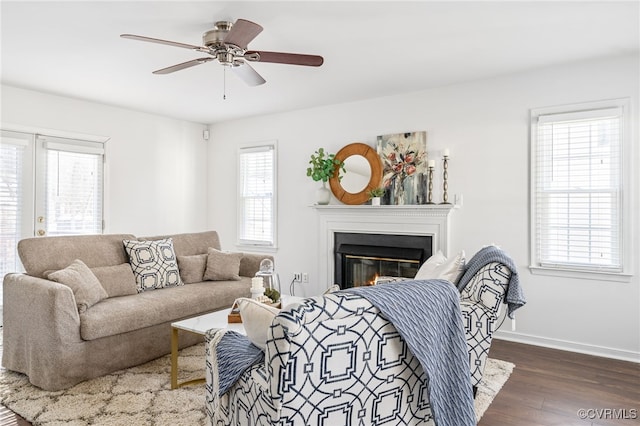 living room with dark wood-type flooring and ceiling fan