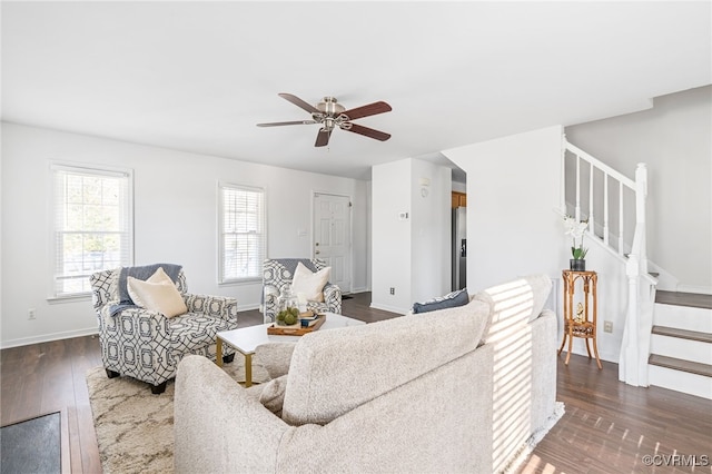 living room with dark wood-type flooring and ceiling fan