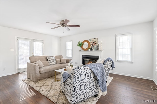 living room with ceiling fan and dark hardwood / wood-style floors