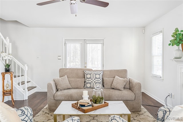 living room featuring ceiling fan, a wealth of natural light, and wood-type flooring