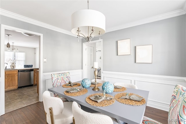 dining space featuring ornamental molding, a notable chandelier, and dark hardwood / wood-style floors