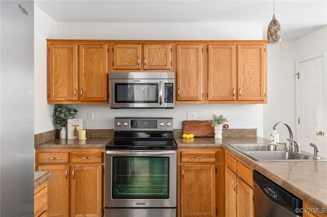 kitchen with decorative light fixtures, appliances with stainless steel finishes, and sink