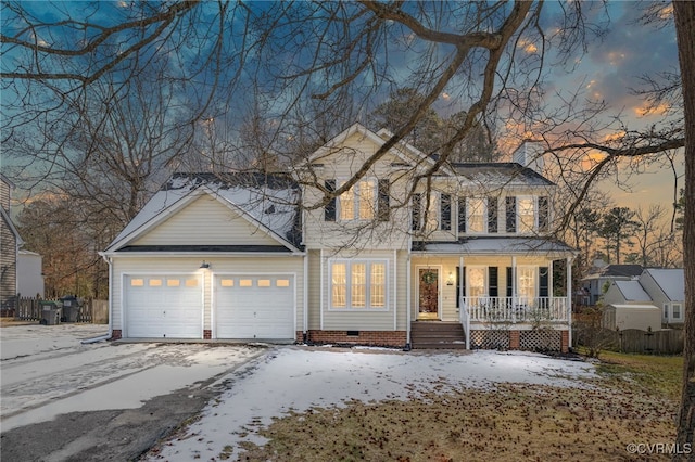 view of front property with covered porch and a garage