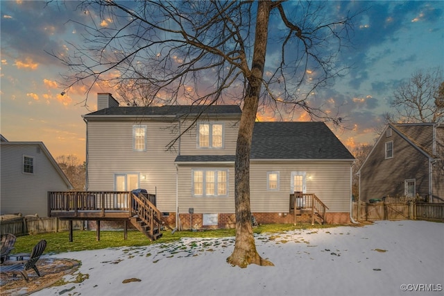 snow covered property with a deck