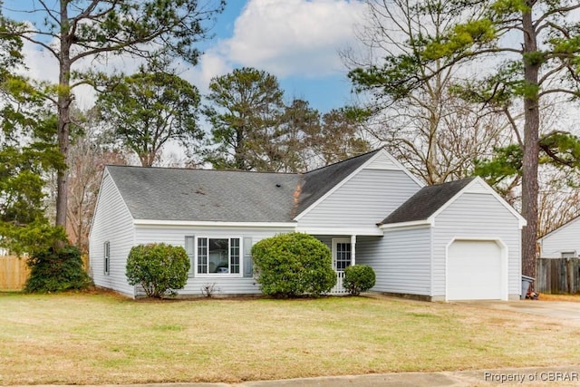 view of front of home with a front lawn and a garage