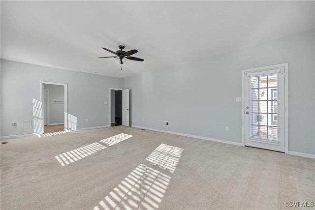 empty room featuring ceiling fan and light carpet