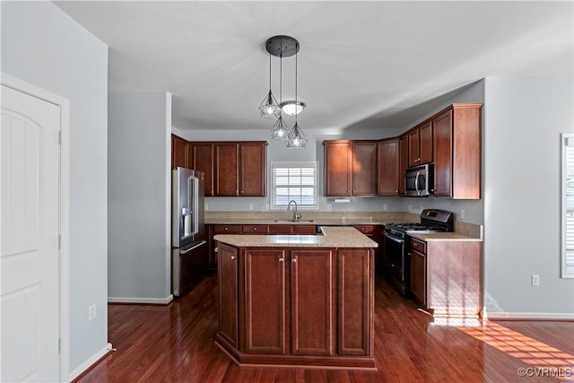 kitchen featuring dark wood-type flooring, decorative light fixtures, a kitchen island, appliances with stainless steel finishes, and sink