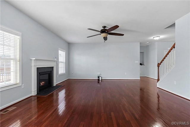 unfurnished living room featuring hardwood / wood-style flooring and ceiling fan