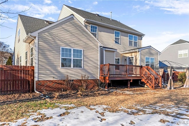 snow covered house featuring a wooden deck and a gazebo